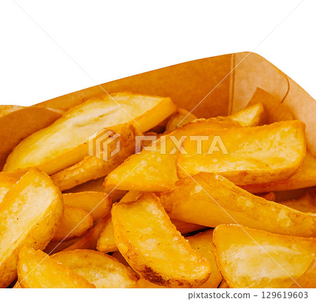 Crispy golden fries served in a cardboard container at a food festival Crispy golden fries served in a cardboard container at a food festival 129619603