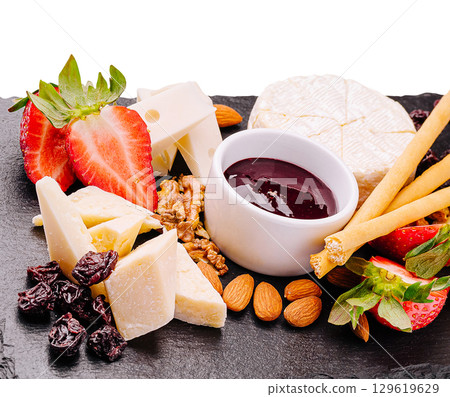 Delicious cheese platter with fruits, nuts, and sweet sauce for snacks 129619629