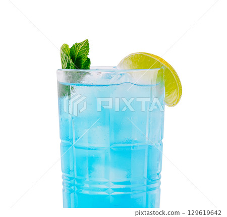 Refreshing blue beverage served with mint and lime garnish in glass Refreshing blue beverage served with mint and lime garnish in glass 129619642