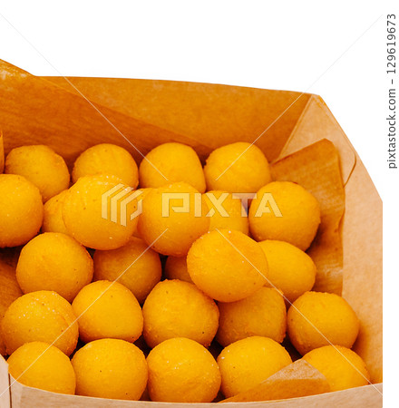 Delicious yellow sweets in a paper box at a local market Delicious yellow sweets in a paper box at a local market 129619673