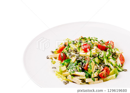 Crisp vegetable salad with seeds and vibrant dressing on a plate Crisp vegetable salad with seeds and vibrant dressing on a plate 129619680