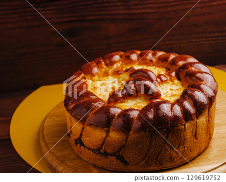 Delicious freshly baked bread dessert with golden crust and rich filling 129619752