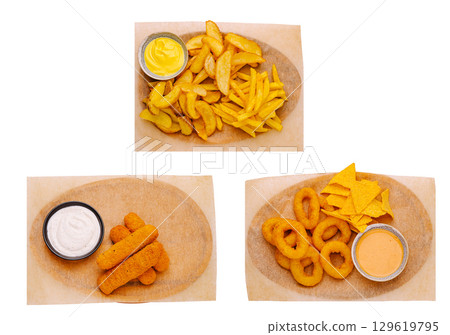 Crispy snacks and delicious dips served on rustic trays in casual setting 129619795