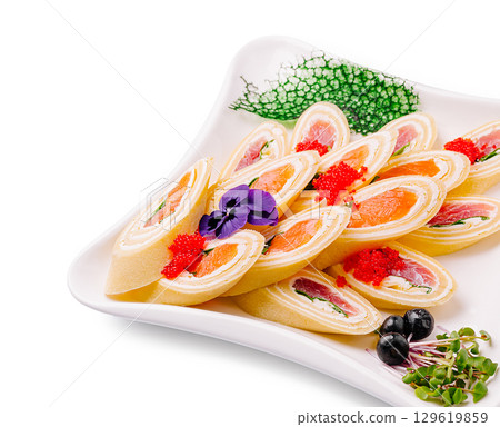 Colorful sushi rolls served on elegant platter with garnishes 129619859