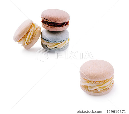 Colorful macarons arranged on a clean surface with a soft background 129619871