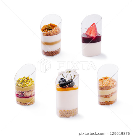 Delicious dessert cups with layers of cream and fruit served at a bakery Delicious dessert cups with layers of cream and fruit served at a bakery 129619876