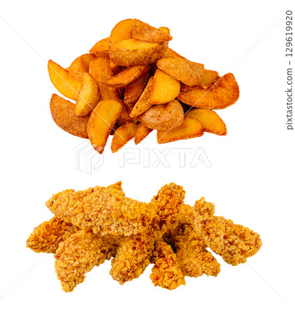 Crispy fried chicken and golden potato wedges served together on a plate 129619920