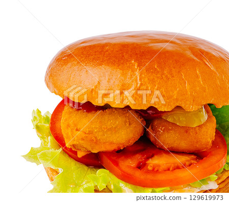 Delicious burger with crispy patties and fresh vegetables served at lunchtime 129619973