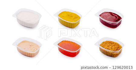 Assortment of colorful dipping sauces arranged in separate containers 129620013