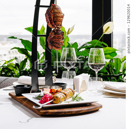 Gourmet skewered meat and sides in a modern dining experience Gourmet skewered meat and sides in a modern dining experience 129620014