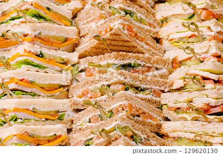 Delicious assorted sandwich platter prepared for a lunchtime gathering Delicious assorted sandwich platter prepared for a lunchtime gathering 129620130