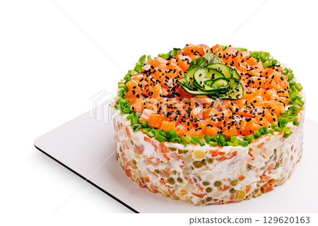 Colorful vegetable and salmon salad cake garnished with cucumber slices Colorful vegetable and salmon salad cake garnished with cucumber slices 129620163