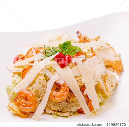 Shrimp salad with crunchy bread and cheese on a white plate served for lunch 129620170