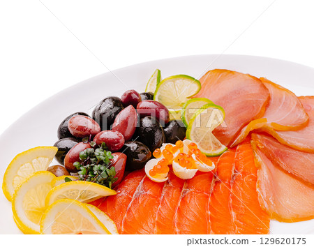 Fresh seafood platter featuring smoked salmon, olives, and citrus garnishes Fresh seafood platter featuring smoked salmon, olives, and citrus garnishes 129620175