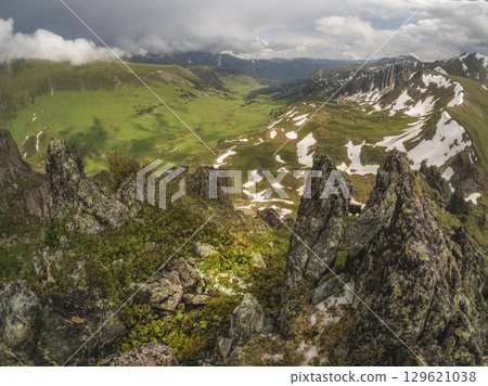 Magnificent mountain landscape, green valley Magnificent mountain landscape, green valley 129621038