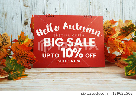 Hello Autumn Big Sale 10% text with maple leaf decorated on wooden background Hello Autumn Big Sale 10% text with maple leaf decorated on wooden background 129621502
