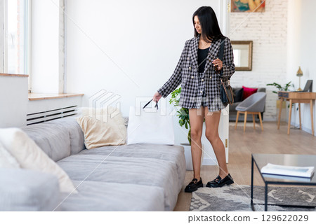 Woman came home with her shopping 129622029