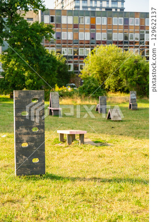 Urban dog training ground with wooden obstacles, ramps and agility equipment in public park, concept of pet friendly cities and outdoor canine activity spaces Urban dog training ground with wooden obstacles, ramps and agility equipment in public park, concept of pet friendly cities and outdoor canine activity spaces 129622137