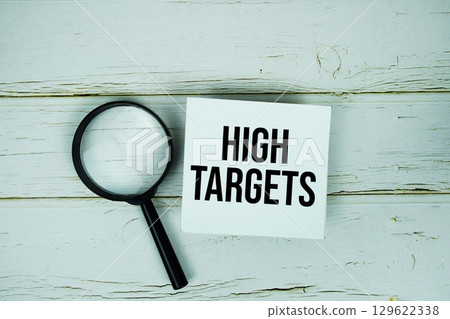 High Targets text message on paper with magnifying glass on wooden background High Targets text message on paper with magnifying glass on wooden background 129622338
