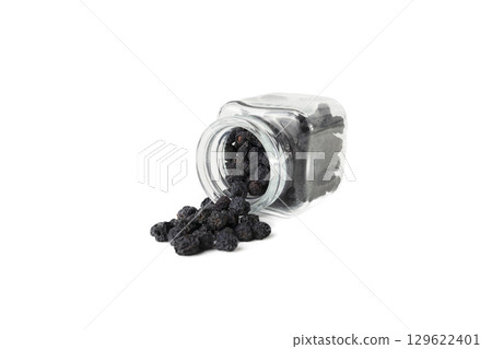 Dried Prunus spinosa, called blackthorn or sloe falling from glass jar isolated on white background. 129622401