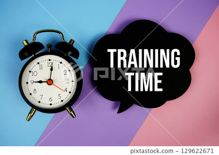 Training Time text on speech bubble with alarm clock top view on  blue, purple and pink geometric background 129622671