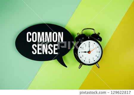 Common Sense text on speech bubble top view on green and yellow geometric background 129622817