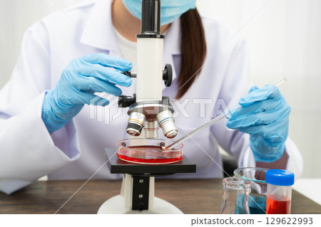 Scientist medical professional use microscope for research in science laboratory. Scientist medical professional use microscope for research in science laboratory. 129622993