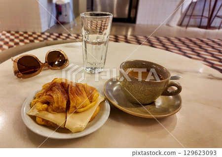 Coffee and croissant served in a cafe 129623093