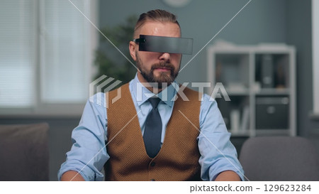 A man is watching holographic screens. A man is watching holographic screens. 129623284