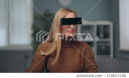 A woman is watching holographic screens. A woman is watching holographic screens. 129623286