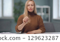 A woman is watching holographic screens. 129623287