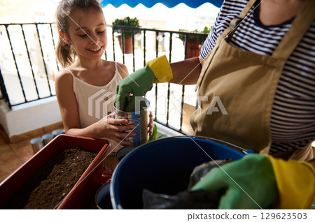 Mother and Daughter Gardening Together on a Balcony Mother and Daughter Gardening Together on a Balcony 129623503