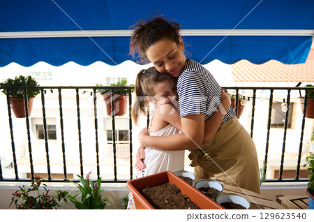 Mother and Daughter Bonding Over Balcony Gardening Activity Together Mother and Daughter Bonding Over Balcony Gardening Activity Together 129623540