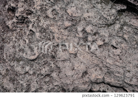 Natural stone terrain with wavy Cross-Bedding texture and black stains spot 129623791
