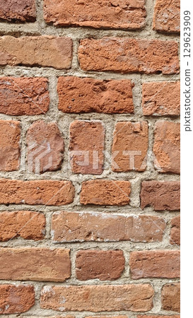 Red brick wall with rough texture and visible cement joints. Concept of construction material, architecture and urban design Red brick wall with rough texture and visible cement joints. Concept of construction material, architecture and urban design 129623909