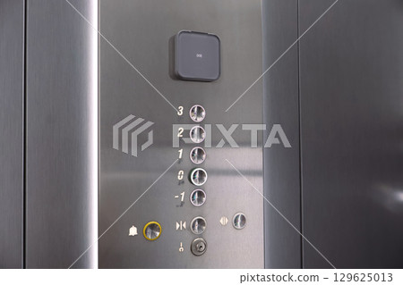Close-Up of Metal Elevator Buttons with Floor Indicators 129625013
