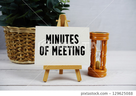 Minutes Of Meeting text with hourglass on wooden background 129625088