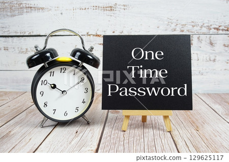 One Time Password text with easel and alarm clock on wooden background 129625117