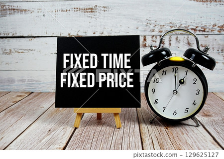 Fixed Time Fixed Price text with easel and alarm clock on wooden background 129625127