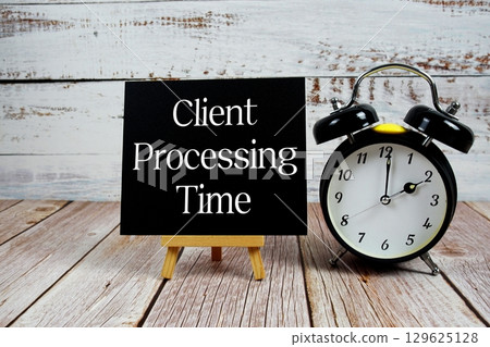Client Processing Time text with easel and alarm clock on wooden background 129625128
