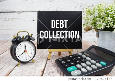 Debt Collection text with alarm clock and calculator on wooden background 129625172