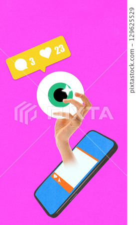 Collage of hand holding stylized eyeball emerging from smartphone with social media notifications on bright pink background 129625529