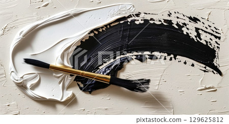 Paintbrush creating abstract black and white painting with brushstrokes 129625812