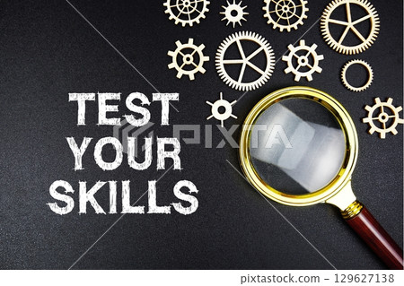 Test Your Skills text message with magnifying glass on black background Test Your Skills text message with magnifying glass on black background 129627138