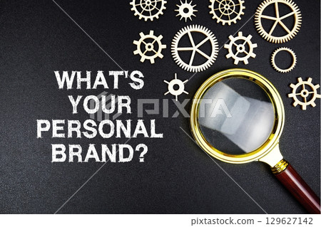 What's Your Personal Brand? text message on sticky note with magnifying glass on black background 129627142