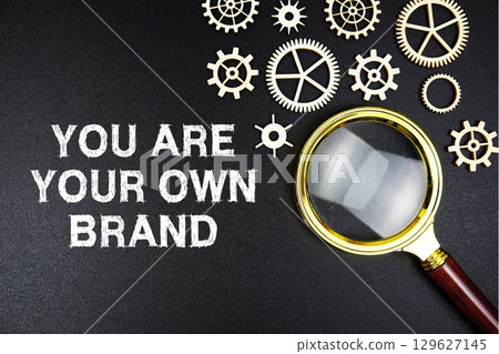 You Are Your Own Brand text message with magnifying glass on black background 129627145