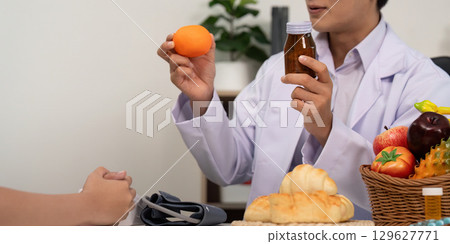 Fruit Nutrition. Doctor showcasing healthy fruit options during a patient consultation. 129627771
