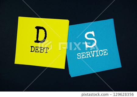 Debt Service (DS) text message on stick note on black background Debt Service (DS) text message on stick note on black background 129628356
