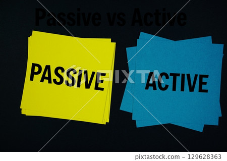 Passive vs Active text with sticky note on black background Passive vs Active text with sticky note on black background 129628363