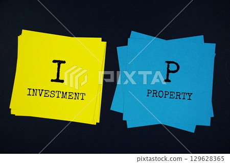Investment Property (IP) text with sticky note on black background Investment Property (IP) text with sticky note on black background 129628365